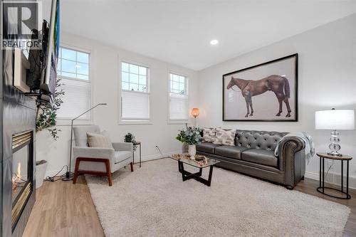 12, 10 St Julien Drive Sw, Calgary, AB - Indoor With Fireplace