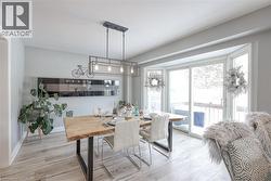 Dining room featuring wood-type flooring and baseboards - 
