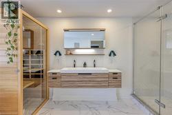 Bathroom with a marble finish shower, double vanity, a sauna / steam room, recessed lighting, and light marble finish flooring - 
