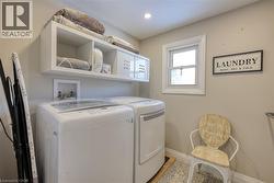 Laundry area featuring baseboards and independent washer and dryer - 