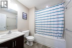 Bathroom featuring vanity and shower / bath combination with curtain - 