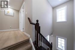 Stairway with wood finished floors and baseboards - 