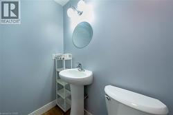 Bathroom with toilet and wood finished floors - 