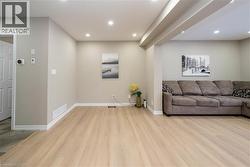 Living area featuring light wood-style floors and recessed lighting - 