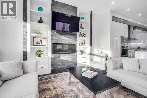 2415 25 Avenue Nw, Calgary, AB - Indoor Photo Showing Living Room With Fireplace