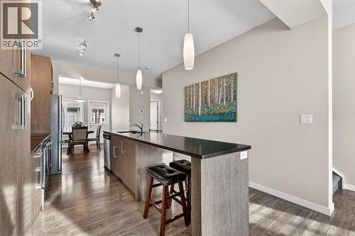 Generous island/eating bar - 330 Marquis Lane Se, Calgary, AB - Indoor