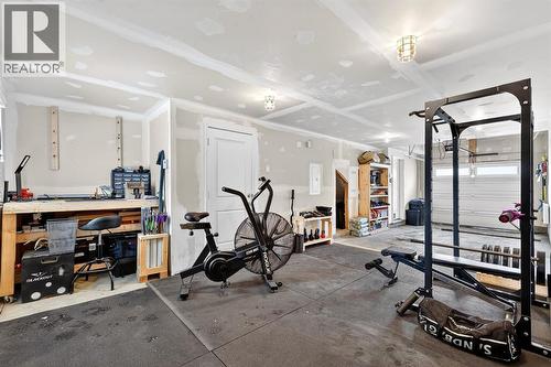 Park 2 vehicles/home gym/storage - 330 Marquis Lane Se, Calgary, AB - Indoor Photo Showing Gym Room