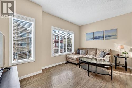 Large windows/tons of natural light - 330 Marquis Lane Se, Calgary, AB - Indoor Photo Showing Living Room
