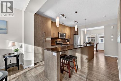 Extended Quartz countertop - 330 Marquis Lane Se, Calgary, AB - Indoor Photo Showing Kitchen With Stainless Steel Kitchen With Upgraded Kitchen