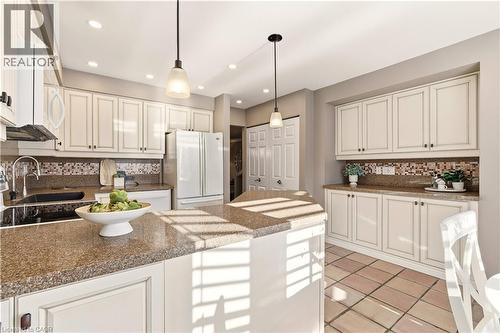 Kitchen featuring backsplash, hanging light fixtures, white appliances, white cabinetry, and recessed lighting - 1489 Litchfield Road, Oakville, ON - Indoor Photo Showing Kitchen With Upgraded Kitchen