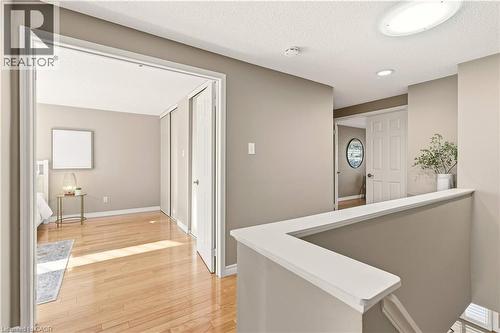 Hall featuring light wood-style flooring, an upstairs landing, a textured ceiling, and recessed lighting - 1489 Litchfield Road, Oakville, ON - Indoor Photo Showing Other Room