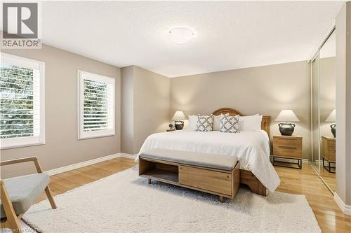 Bedroom with a closet, a textured ceiling, and light wood-style flooring - 1489 Litchfield Road, Oakville, ON - Indoor Photo Showing Bedroom