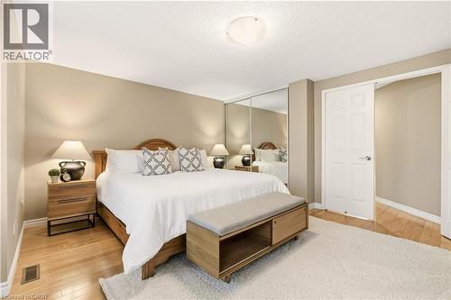 Bedroom featuring light wood-style floors, a closet, and a textured ceiling - 1489 Litchfield Road, Oakville, ON - Indoor Photo Showing Bedroom