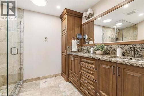 Full bathroom with double vanity, tasteful backsplash, a stall shower, and light stone finish floors - 1489 Litchfield Road, Oakville, ON - Indoor Photo Showing Bathroom
