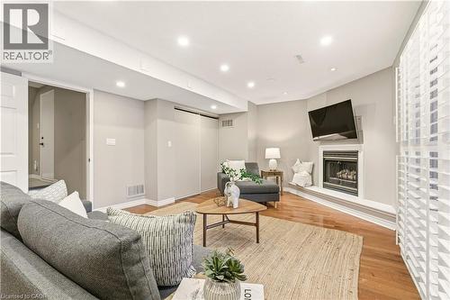 Living area with a glass covered fireplace, light wood-style floors, and recessed lighting - 1489 Litchfield Road, Oakville, ON - Indoor Photo Showing Living Room With Fireplace