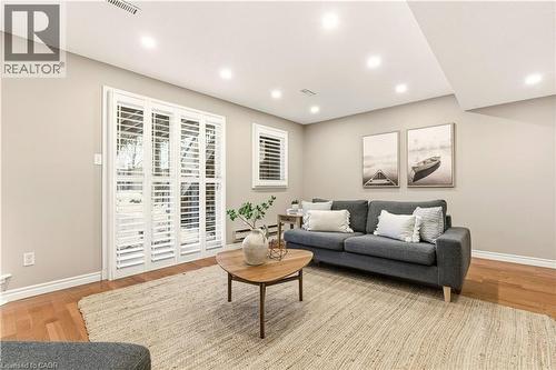 Living area featuring light wood finished floors, recessed lighting, and a baseboard heating unit - 1489 Litchfield Road, Oakville, ON - Indoor Photo Showing Living Room