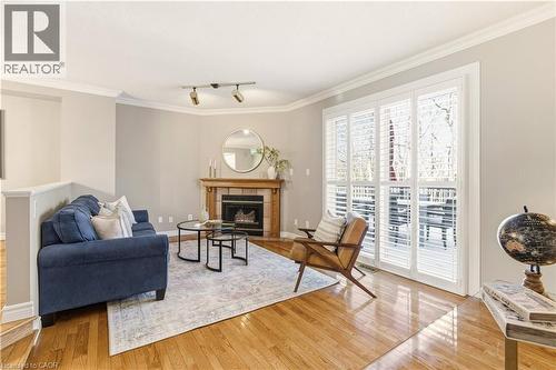 Sunken living room with fireplace and walkout - 1489 Litchfield Road, Oakville, ON - Indoor Photo Showing Living Room With Fireplace