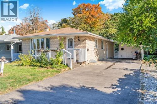 Single story home with asphalt driveway, brick siding, a chimney, and an attached carport - 146 Appalachian Crescent Unit# Upper, Kitchener, ON - Outdoor