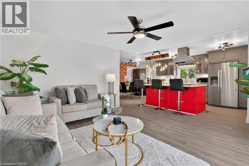 Living area featuring dark wood-type flooring, a ceiling fan, and crown molding - 146 Appalachian Crescent Unit# Upper, Kitchener, ON - Indoor Photo Showing Living Room