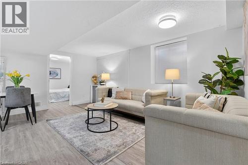 Living area featuring light wood-style floors and a textured ceiling - 146 Appalachian Crescent Unit# Lower, Kitchener, ON - Indoor Photo Showing Living Room
