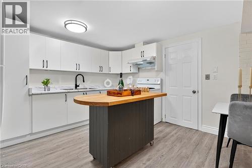 Kitchen featuring wooden counters, white cabinetry, and light wood-style flooring - 146 Appalachian Crescent Unit# Lower, Kitchener, ON - Indoor Photo Showing Kitchen