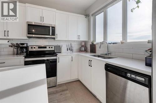 Stainless Steel Appliances - 1969 Rangeview Drive Se, Calgary, AB - Indoor Photo Showing Kitchen With Stainless Steel Kitchen With Double Sink