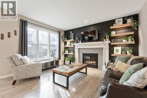 159 Riviera View, Cochrane, AB - Indoor Photo Showing Living Room With Fireplace