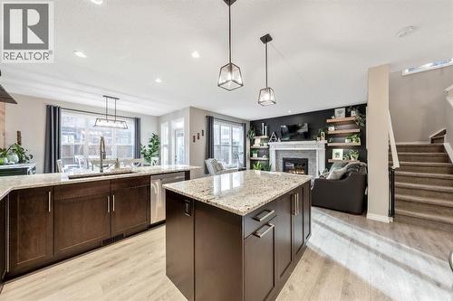 159 Riviera View, Cochrane, AB - Indoor Photo Showing Kitchen With Fireplace With Double Sink