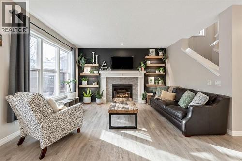 159 Riviera View, Cochrane, AB - Indoor Photo Showing Living Room With Fireplace