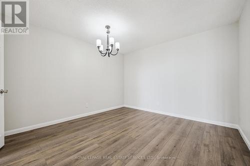 Dining Room Features Engineered Hardwood Flooring - 702 - 1240 Marlborough Court, Oakville, ON - Indoor Photo Showing Other Room