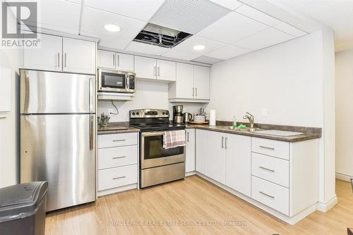 Party Room with Kitchen - 702 - 1240 Marlborough Court, Oakville, ON - Indoor Photo Showing Kitchen With Double Sink