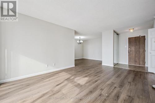 Living Room Features Engineered Hardwood Flooring - 702 - 1240 Marlborough Court, Oakville, ON - Indoor Photo Showing Other Room
