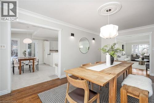 Dining space with light wood-style flooring and ornamental molding - 4226 Dunvegan Road, Burlington, ON - Indoor Photo Showing Dining Room