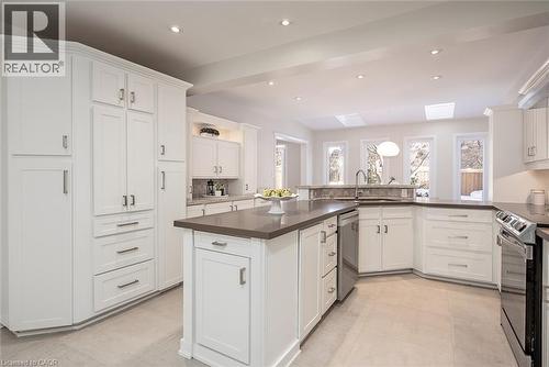 Kitchen featuring a skylight, electric stove, white cabinets, recessed lighting, and stainless steel dishwasher - 4226 Dunvegan Road, Burlington, ON - Indoor Photo Showing Kitchen With Upgraded Kitchen