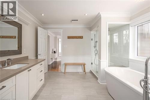 Full bath with a shower stall, vanity, a freestanding bath, wainscoting, and crown molding - 4226 Dunvegan Road, Burlington, ON - Indoor Photo Showing Bathroom