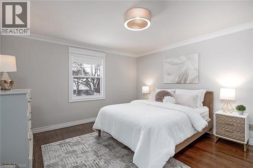 Bedroom featuring ornamental molding and dark wood-style flooring - 4226 Dunvegan Road, Burlington, ON - Indoor Photo Showing Bedroom