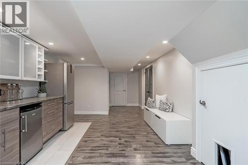 Kitchen featuring open shelves, recessed lighting, stainless steel appliances, light wood-type flooring, and glass insert cabinets - 4226 Dunvegan Road, Burlington, ON - Indoor