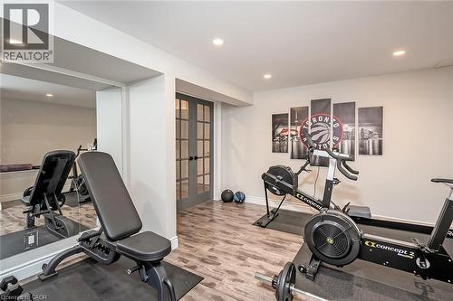 Exercise area with recessed lighting, french doors, and light wood-style floors - 4226 Dunvegan Road, Burlington, ON - Indoor Photo Showing Gym Room