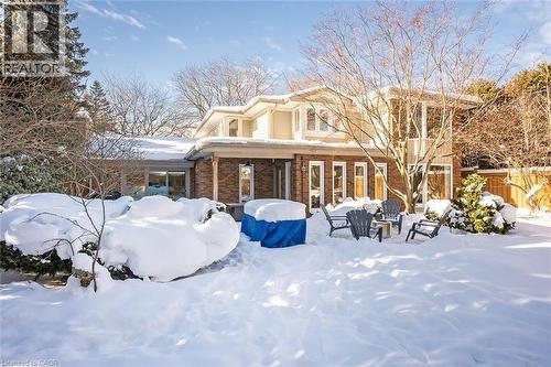 Snow covered back of property with a patio area and brick siding - 4226 Dunvegan Road, Burlington, ON - Outdoor