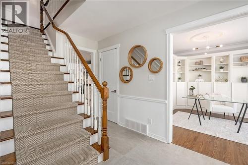 Staircase with baseboards and wood finished floors - 4226 Dunvegan Road, Burlington, ON - Indoor Photo Showing Other Room