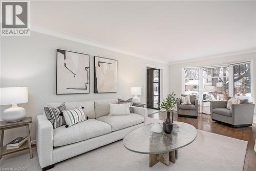 Living area featuring ornamental molding and wood finished floors - 4226 Dunvegan Road, Burlington, ON - Indoor Photo Showing Living Room