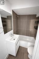 Bathroom with shower / bathtub combination and vanity - 