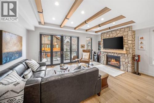 4, 810 3Rd Street, Canmore, AB - Indoor Photo Showing Living Room With Fireplace