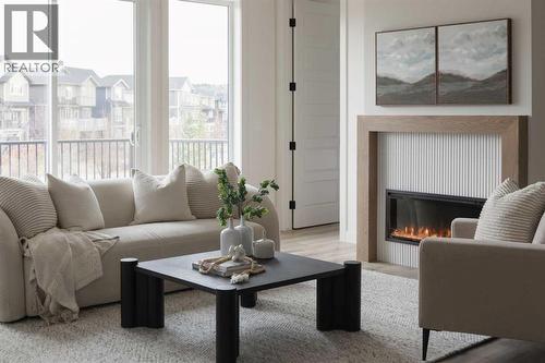 88 Sunrise Heath, Cochrane, AB - Indoor Photo Showing Living Room With Fireplace