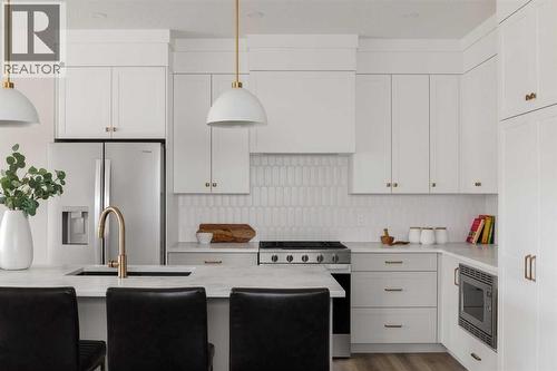 88 Sunrise Heath, Cochrane, AB - Indoor Photo Showing Kitchen With Upgraded Kitchen