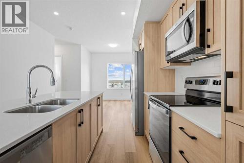 1506, 25 Wildwoods Court Sw, Airdrie, AB - Indoor Photo Showing Kitchen With Stainless Steel Kitchen With Double Sink
