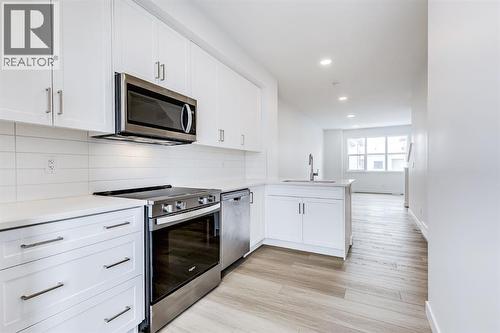 202, 437 Alpine Avenue Sw, Calgary, AB - Indoor Photo Showing Kitchen With Upgraded Kitchen