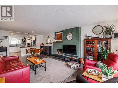 Enjoy your wood burning fireplace - 865 Theodora Road, Kelowna, BC - Indoor Photo Showing Living Room With Fireplace