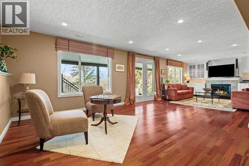 63 Springbank Crescent Sw, Calgary, AB - Indoor Photo Showing Living Room With Fireplace