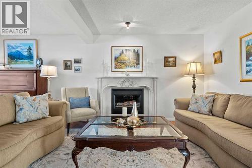 63 Springbank Crescent Sw, Calgary, AB - Indoor Photo Showing Living Room With Fireplace